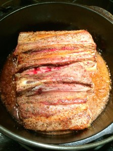 The short ribs placed on their sides to simmer.