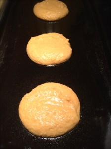 Pumpkin Spice Pancakes cooking on the griddle.